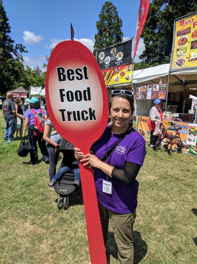 Kris with an enormous wooden spoon, which designates the winning Food Truck