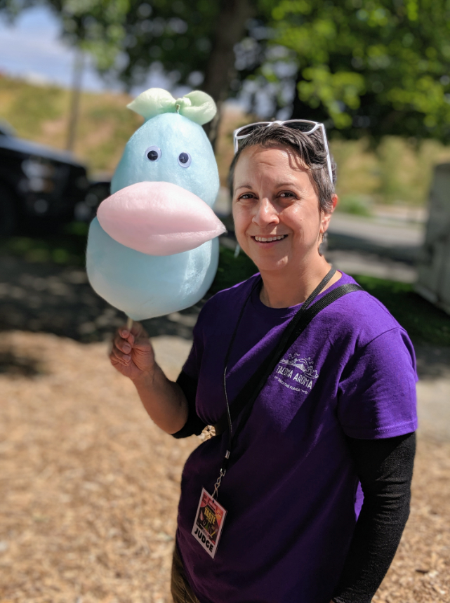 Kris with a colorful cotton candy creature on a stick